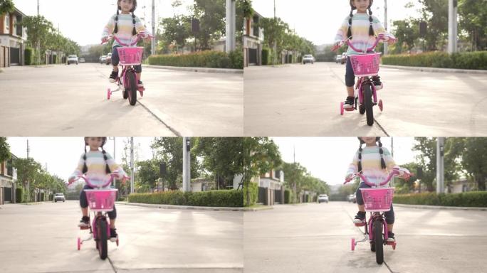 小女孩骑自行车，推动踏板