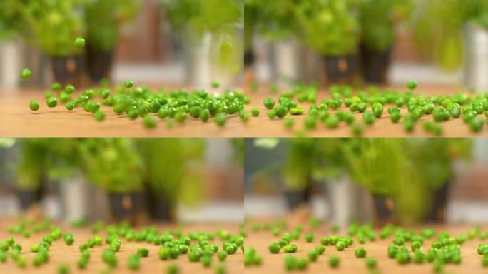 慢动作: 自制绿豌豆从木制柜台上滚下的电影拍摄。