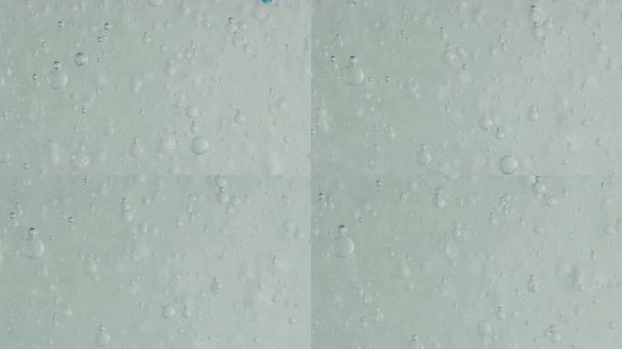 用显微镜分析液体中蓝色微粒分子的慢动作宏观，用于科学实验室的护肤和美容化妆品研究。