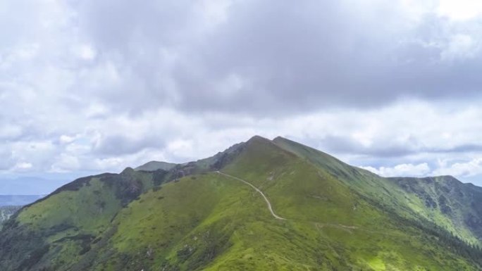 云流背景上绿山之上的飞行。过度下垂