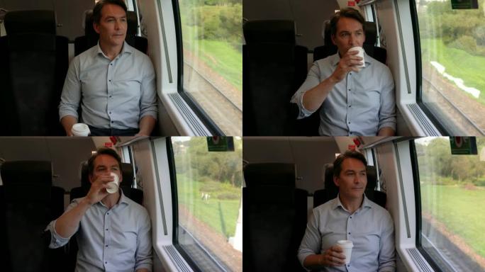 火车上的商人坐着舒适地喝咖啡，一边欣赏窗户的景色
