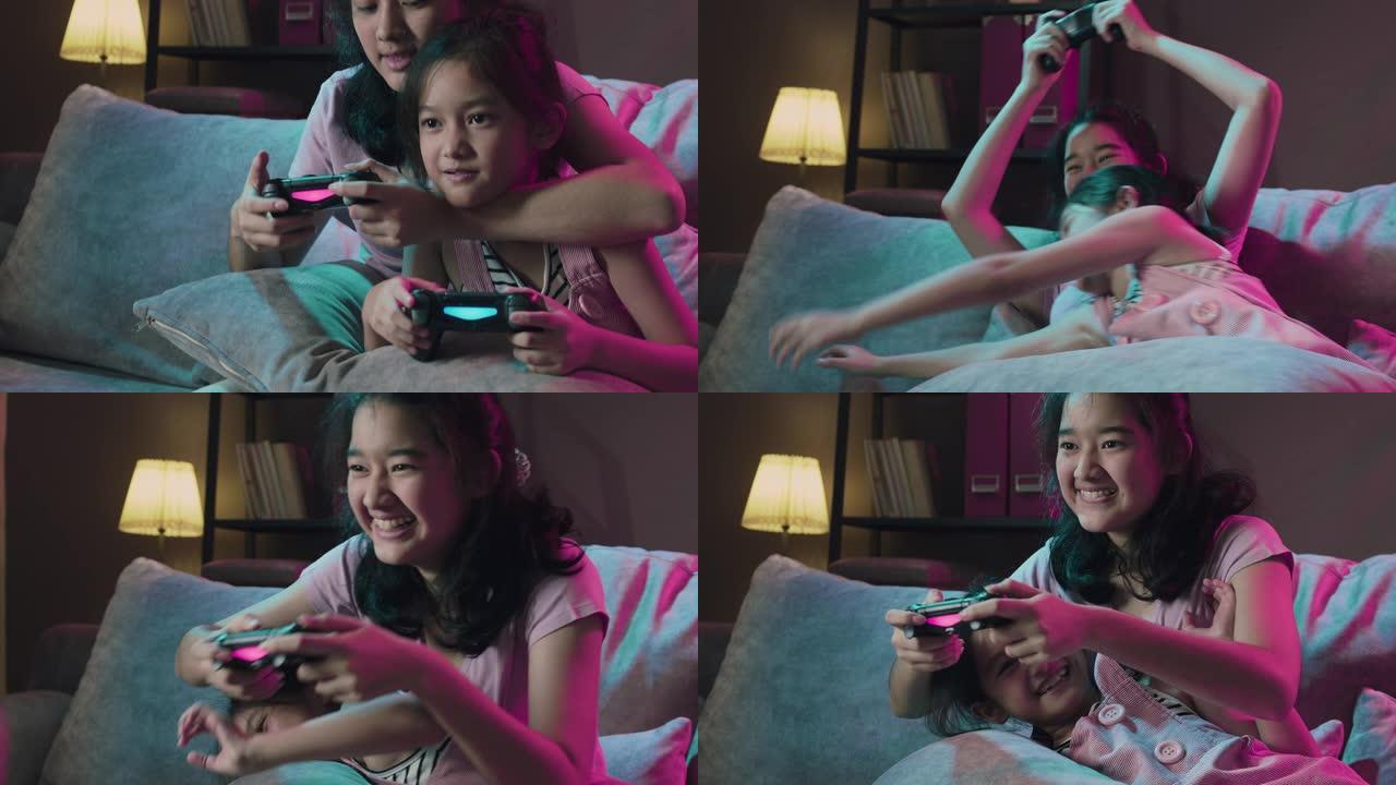 4k分辨率迷人的亚洲兄弟姐妹女孩一起玩电子游戏，并为自己在家里的客厅获胜感到高兴。两个姐姐在家时使用