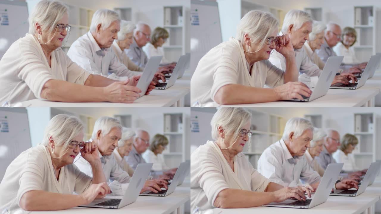 技术课上使用笔记本电脑的老妇人