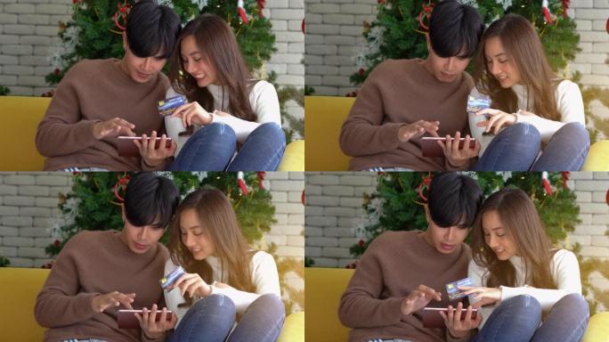 年轻的亚洲夫妇庆祝圣诞节假期并进行在线购物