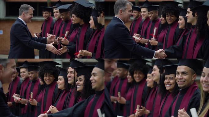 大学男院长握手应届毕业生非常愉快和微笑