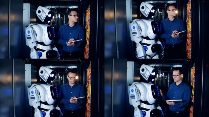 男性IT程序员和机器人，droid在数据中心工作。