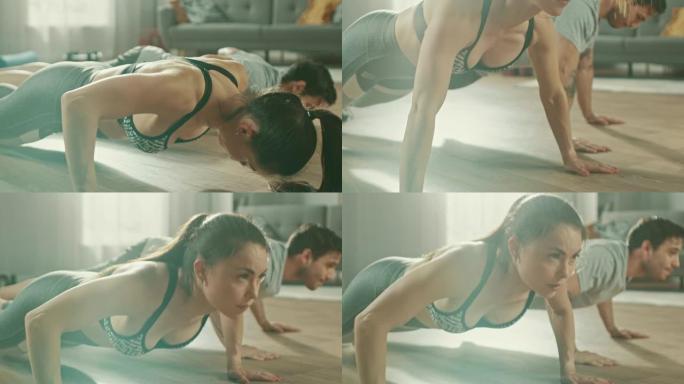 穿着运动服的强壮而美丽的运动健身夫妇在明亮宽敞的客厅进行俯卧撑运动，内部简约。