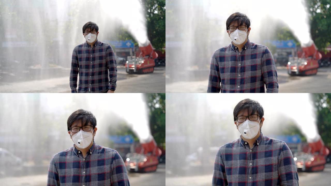 亚洲男子站在消防救援车上用消防水带飞溅喷水空气污染问题背景