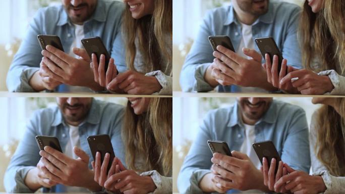 年轻夫妇使用智能手机应用会笑，特写镜头