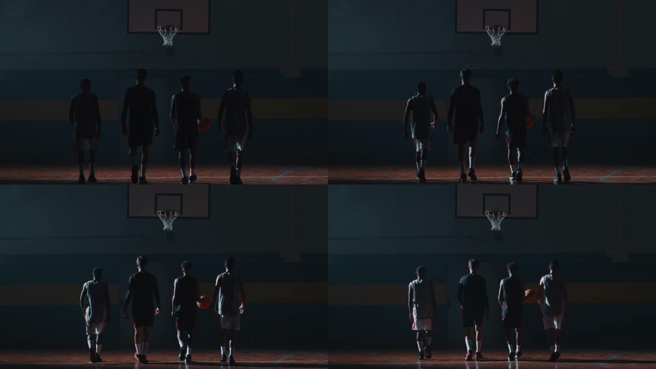 电影慢动作后视图拍摄的年轻职业男球员正走向篮子，然后开始在健身房练习篮球锻炼