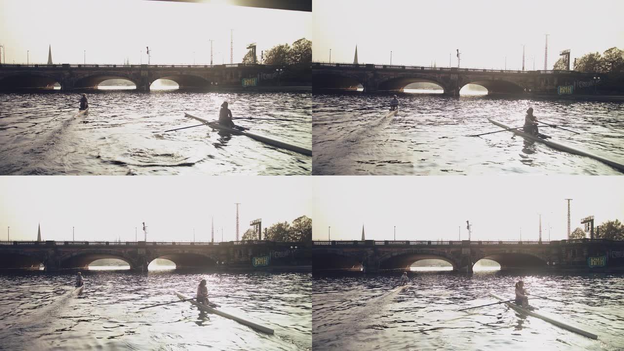 河中的男女划桨船皮划艇休闲娱乐