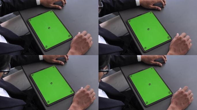 商人在绿屏数字平板电脑上使用和寻找