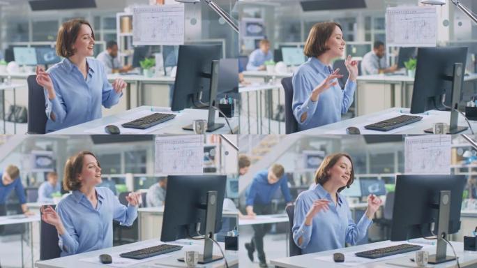 在工业工程设施中: 在台式计算机上工作的聪明美丽的女工程师的肖像，欢快地跳舞并庆祝她的成功。在后台工
