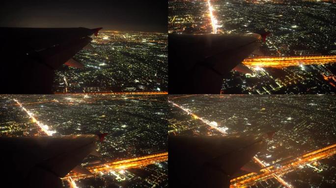 4k起飞夜间飞行飞机机翼和城市从乘客座位窗口视图