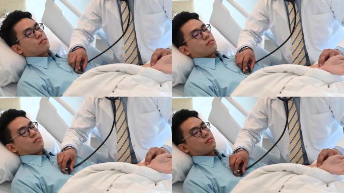 一名亚洲男医生在医院用听诊器对患者进行医疗检查