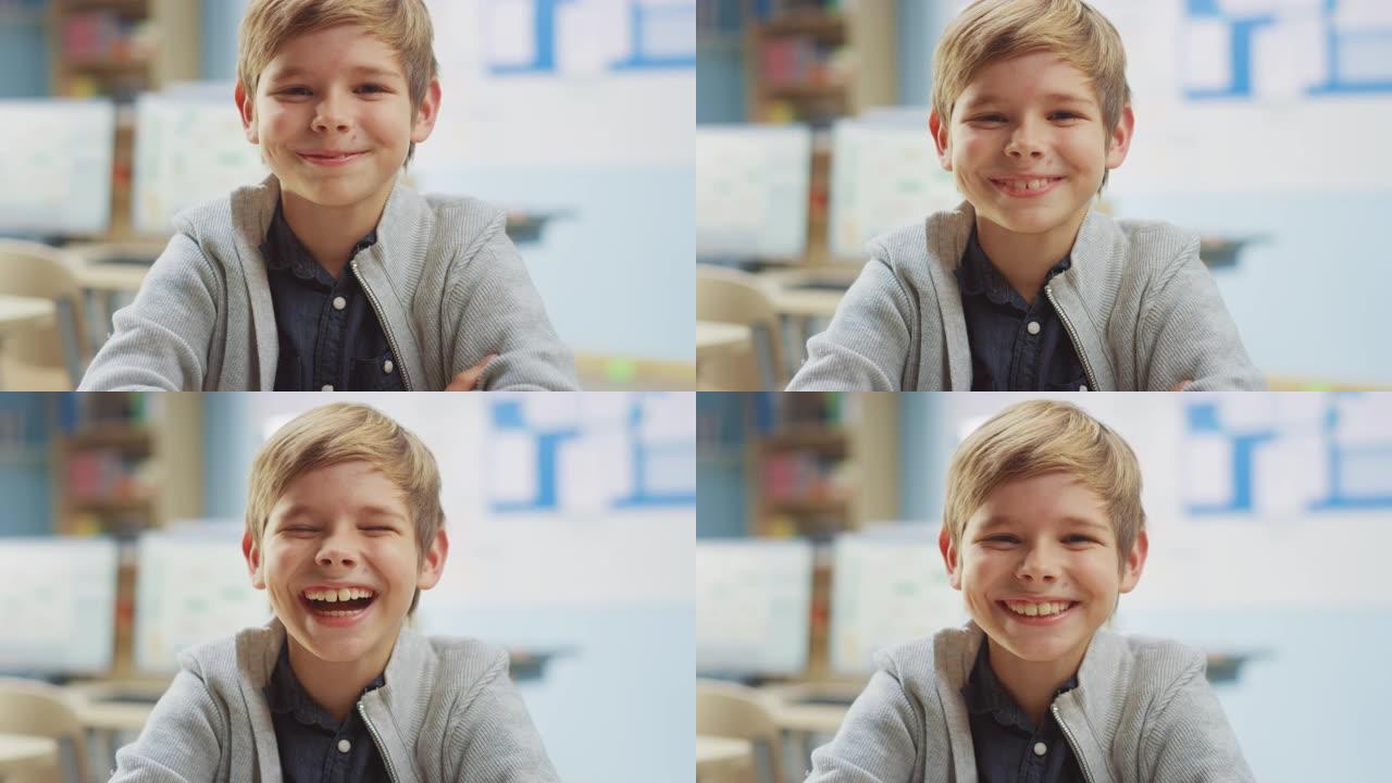 一个可爱的小男孩坐在他的课桌前的肖像，开心地笑了。聪明的小男孩，带着迷人的微笑坐在教室里。提升相机拍