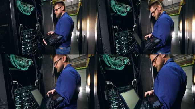 男性专家正在操作一台插电式笔记本电脑