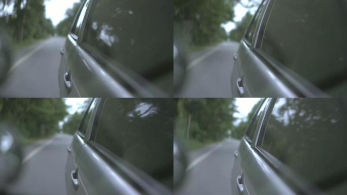 车窗上的反射。汽车驾驶的镜头，慢动作