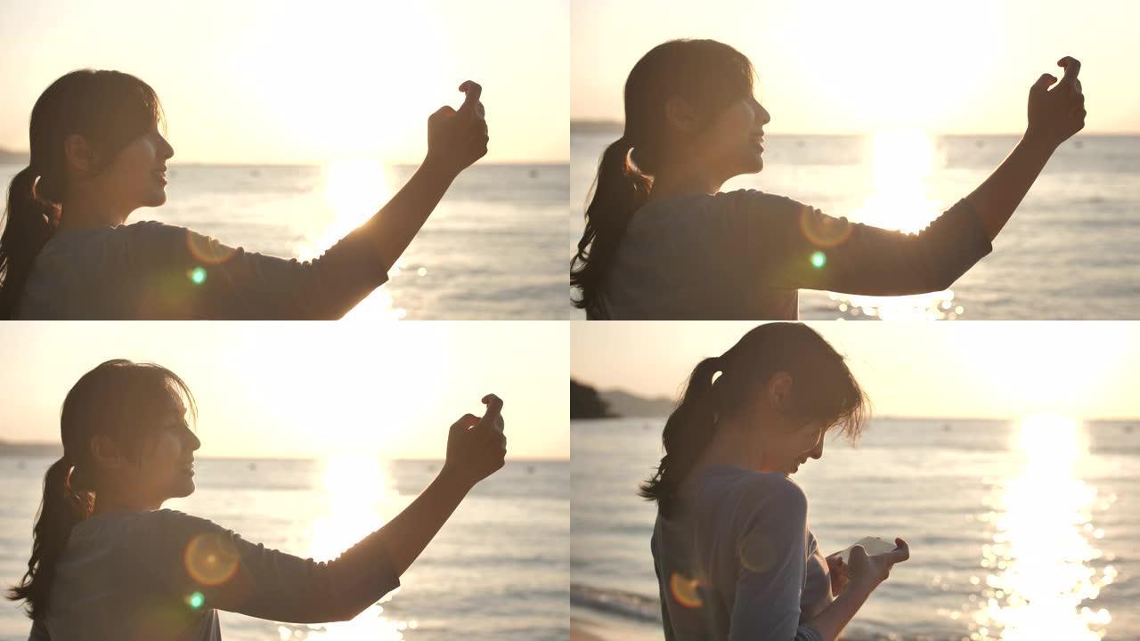 亚洲女人拍照海滩海边玩耍海边自拍景区打卡