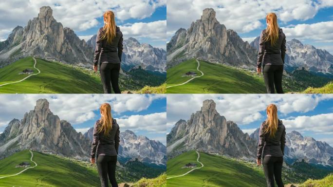 女游客探索意大利山腰，徒步旅行，欣赏白云岩Giau山口的景色