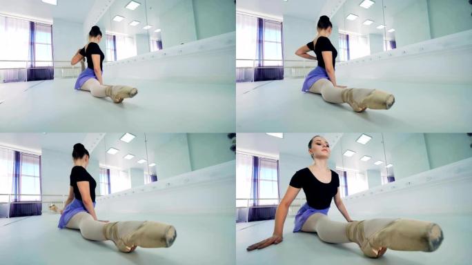 芭蕾舞女演员在镜子附近训练时伸展身体，特写镜头。