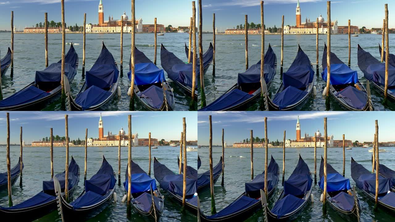 意大利威尼斯。停靠的吊船上覆盖着在海浪中摇曳的蓝色画布。背景中可以看到圣马可大教堂。UHD