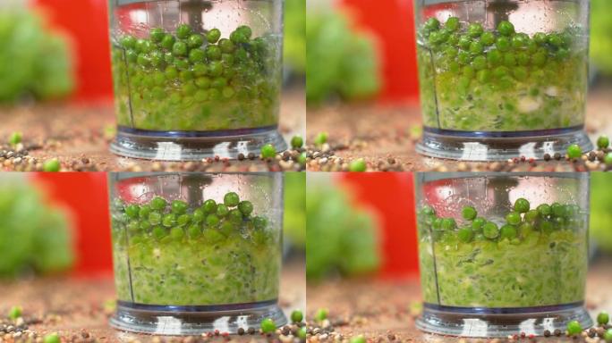 慢动作，宏观: 生有机豌豆在食品加工机中混合。