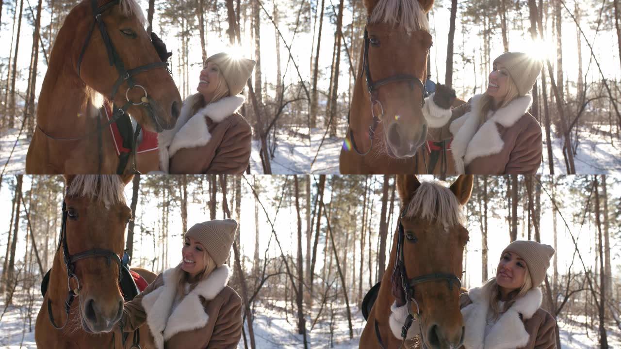 冬日在森林里爱抚马的快乐女人