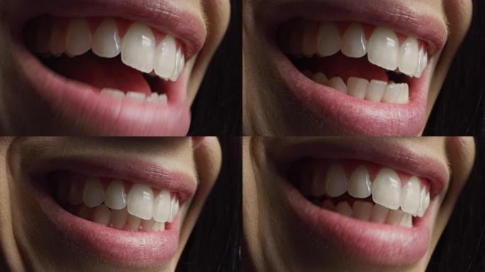 特写三分之三的微距拍摄一颗有着完美洁白牙齿的嘴。人说话，我们看到嘴和舌头的运动。女人有着美丽的自然健
