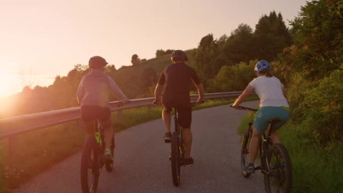 慢动作: 日出时，旅行者骑着电动自行车探索乡村景观。