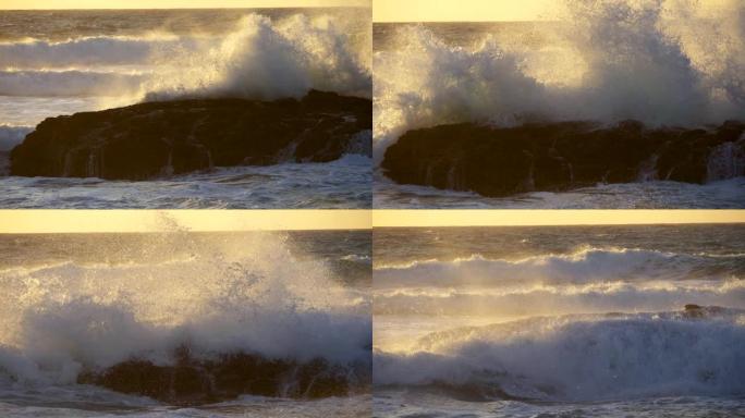 葡萄牙的大西洋海浪击中了一块黑色的岩石。在暴风雨的天气中，日落时被大量泡沫覆盖的水域。UHD