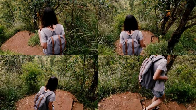 镜头跟随年轻的旅游妇女背着背包走在斯里兰卡山丘上陡峭的热带森林小径慢动作。