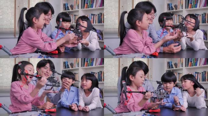 快乐的孩子为学校机器人俱乐部项目学习编程飞机机器人。孩子们爱好休闲生活方式机器人技术智能学习。教育主