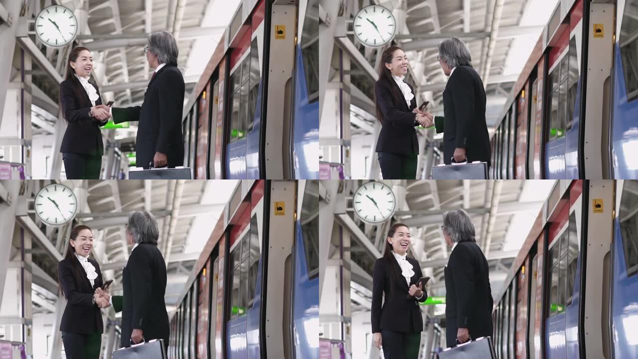 亚洲女商人在地铁站与男人握手的慢动作。
