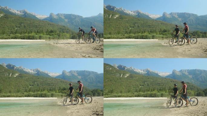 慢动作: 两个家伙骑自行车上一条小溪，观察风景。