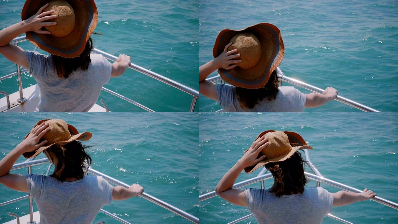 美丽的特写镜头，快乐兴奋的旅游女人戴着旧太阳帽，在海上游艇前面享受阳光航行。