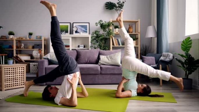 男人和女人在家中倒立姿势做瑜伽体式序列