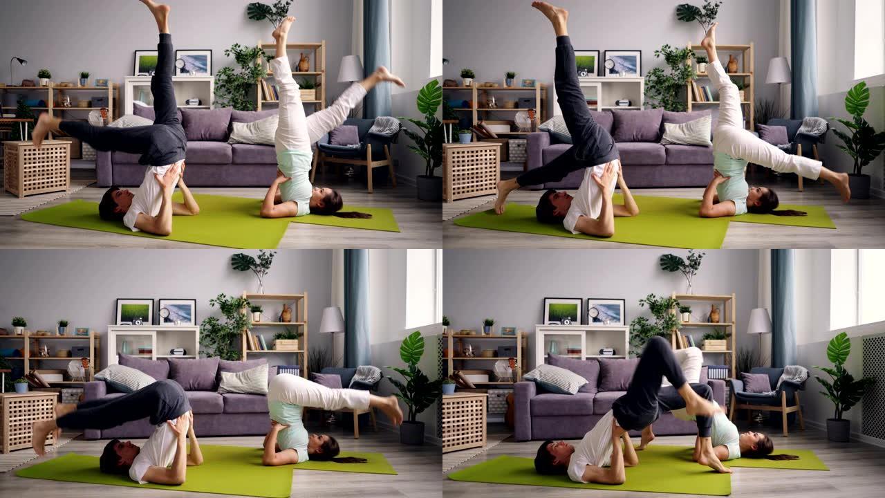 男人和女人在家中倒立姿势做瑜伽体式序列