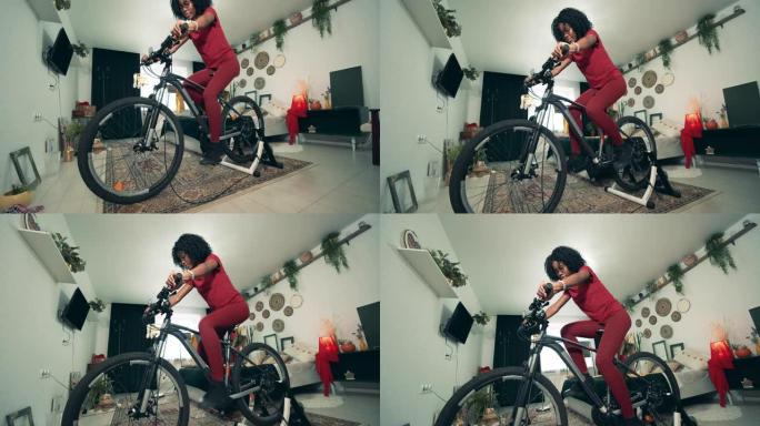 一位非裔美国女士正在使用Exercycle在家进行训练。在家运动，在家健身。