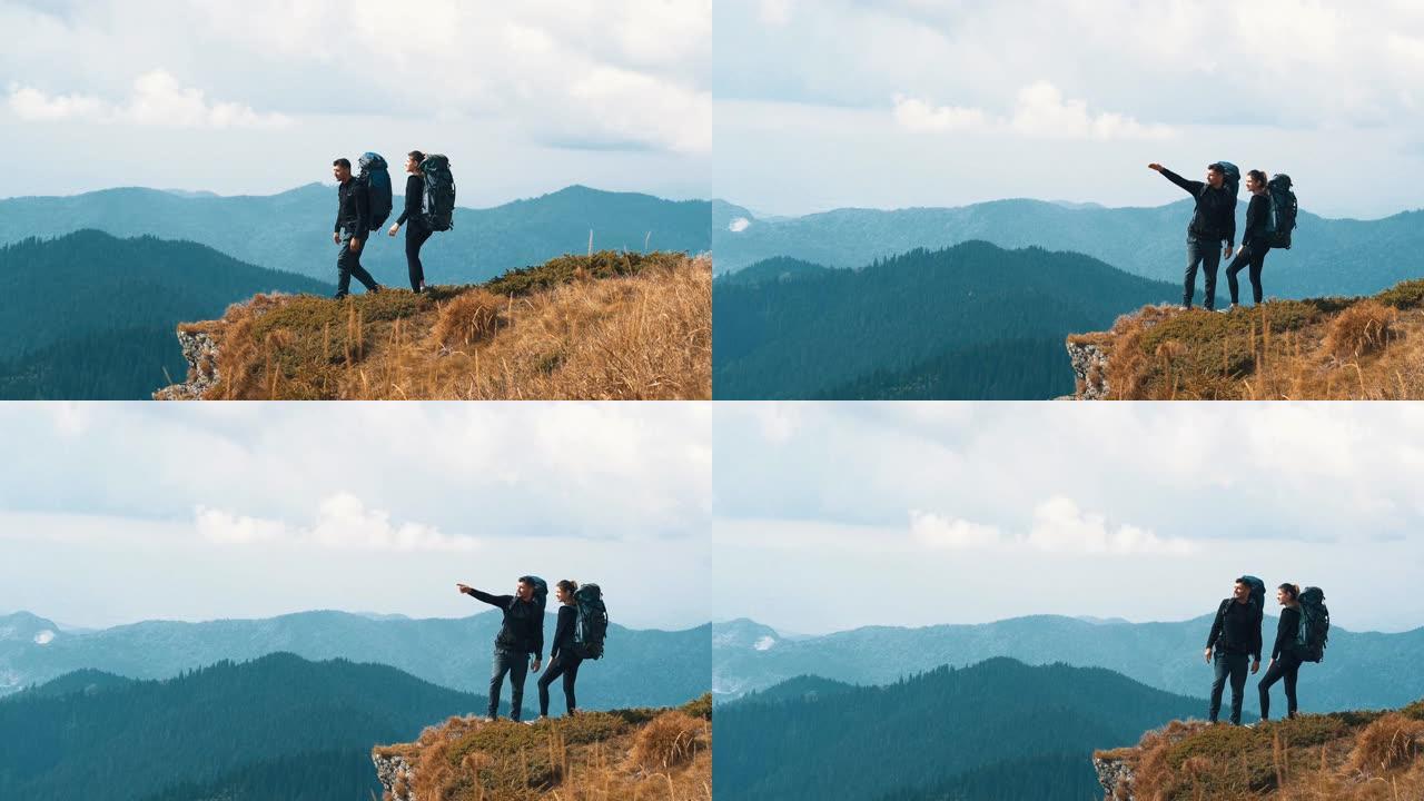 背着背包站在山上的女人和男人