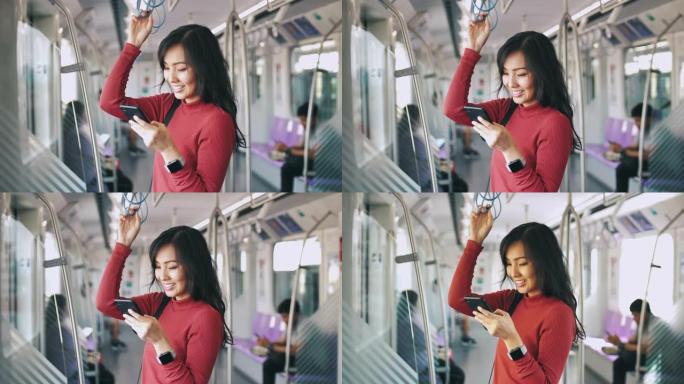 年轻的亚洲妇女在火车上使用电话进行社交网络