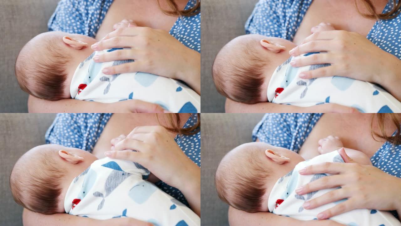母亲坐在沙发上的特写镜头在家中母乳喂养婴儿儿子-慢动作拍摄