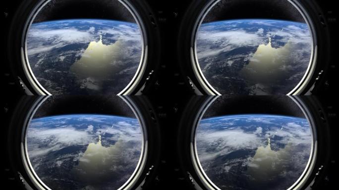 地球穿过国际空间站的大舷窗。车站围绕地球运行。现实的氛围。3D体积云。空间。国际空间站。4K。