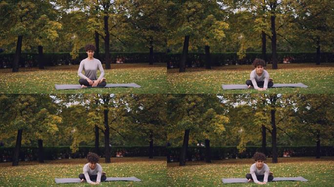 灵活的年轻女士坐在瑜伽姿势的垫子上，享受新鲜空气、宁静和放松。城市人的健康生活方式，活跃的青年和自然