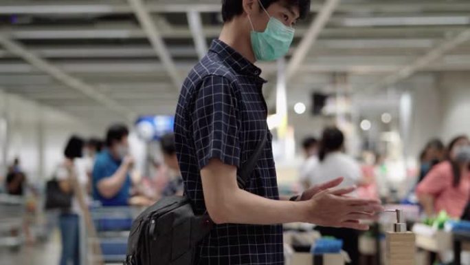 年轻的亚洲男子清理手保护病毒