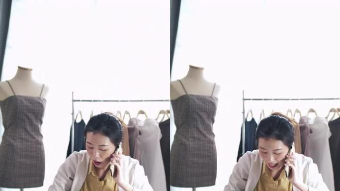 亚洲时装设计师与她的客户通过电话讨论设计师解决方案，垂直