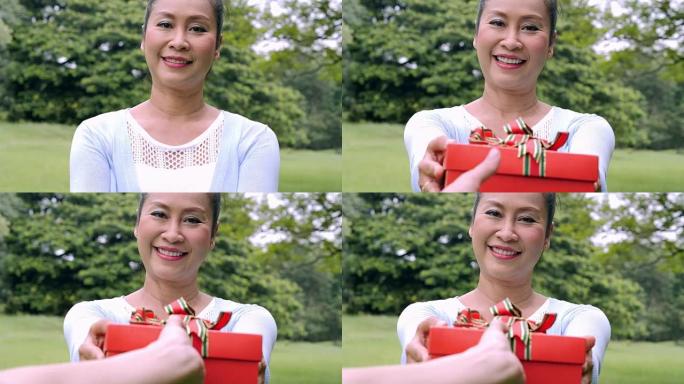 高级女性手握礼品盒，生活方式: 里程碑和庆祝活动