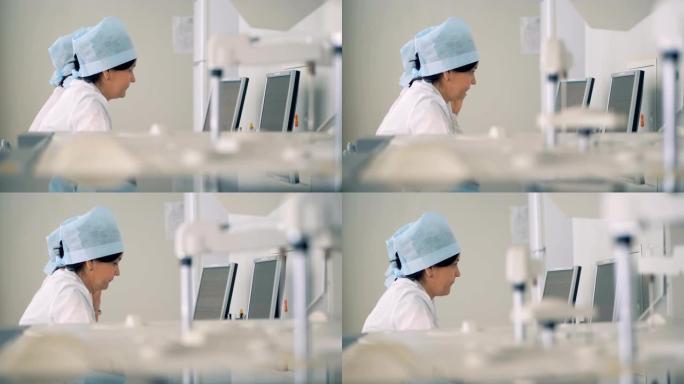 护士使用计算机，而机器进行测试。4K。