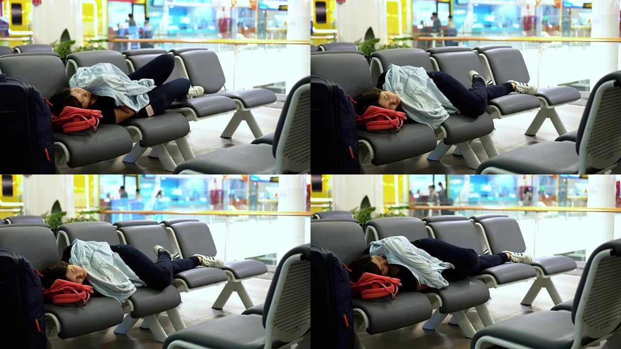 4k镜头有吸引力的亚洲女性旅行者睡觉时带着行李在机场候机楼候机，交通和旅客旅行概念