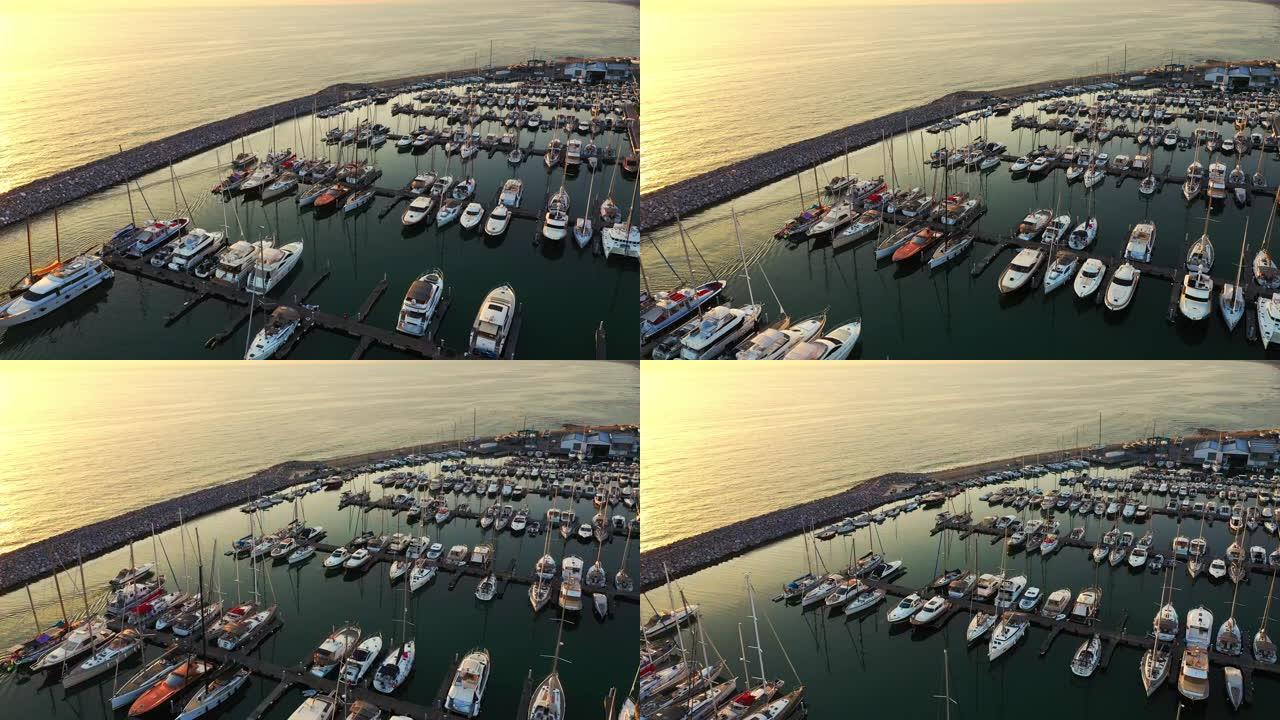 空中无人机镜头: 乘坐不同大小的游艇飞越滨海湾。停放的豪华游艇和渔船